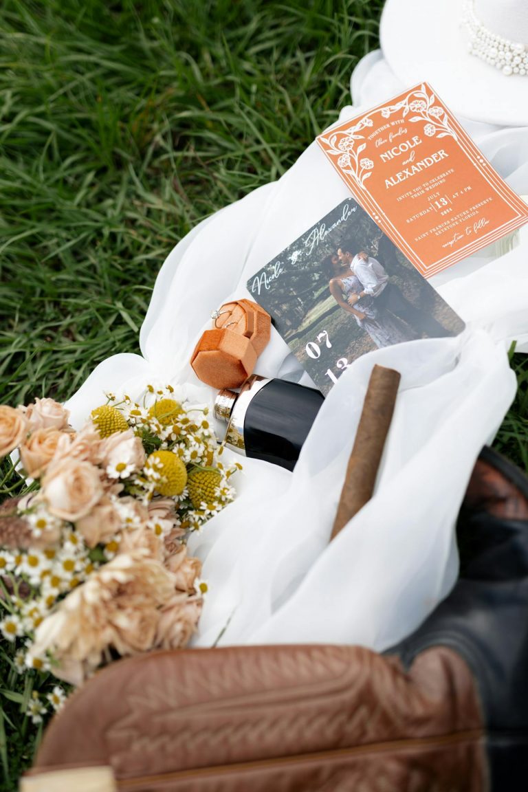 Elegant wedding invitation layout with flowers, cigar, and wedding details.